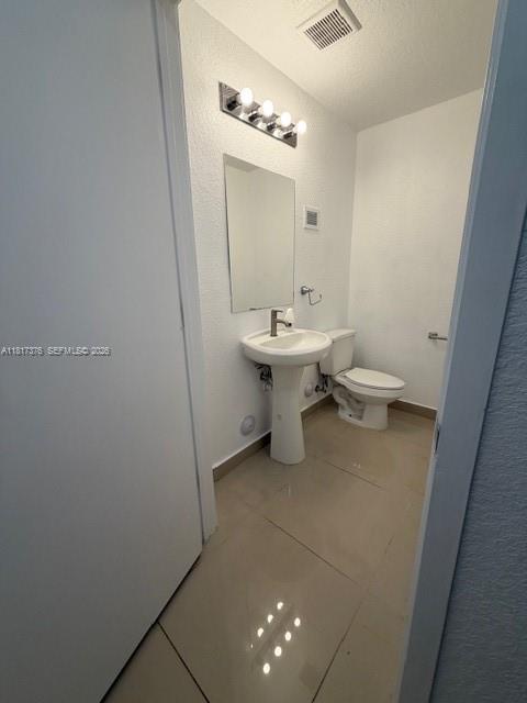 25870 Southwest 144th Court Homestead, FL 33032 - Photo 35 of 46 a bathroom with a sink and mirror with toilet