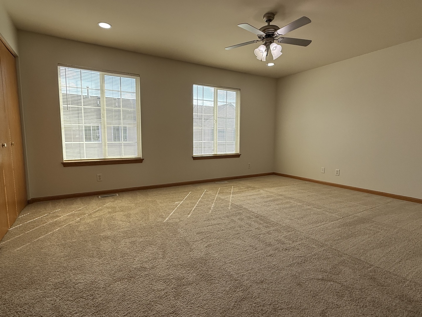 1392 Carolyn Court Yorkville, IL 60560 - Photo 12 of 23 an empty room with windows and ceiling fan