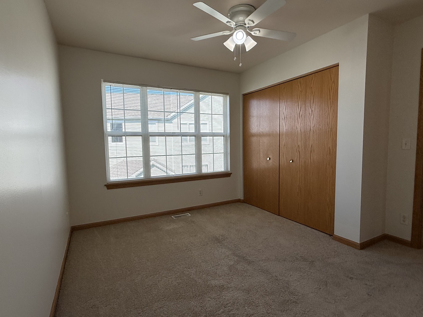 1392 Carolyn Court Yorkville, IL 60560 - Photo 19 of 23 an empty room with windows and fan