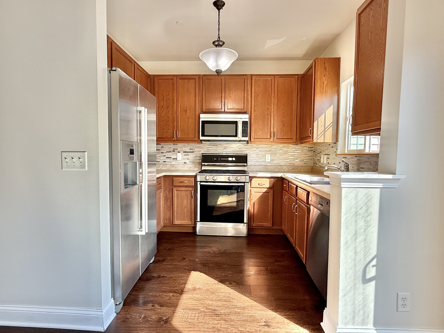 1392 Carolyn Court Yorkville, IL 60560 - Photo 4 of 23 a kitchen with wooden floors and stainless steel appliances