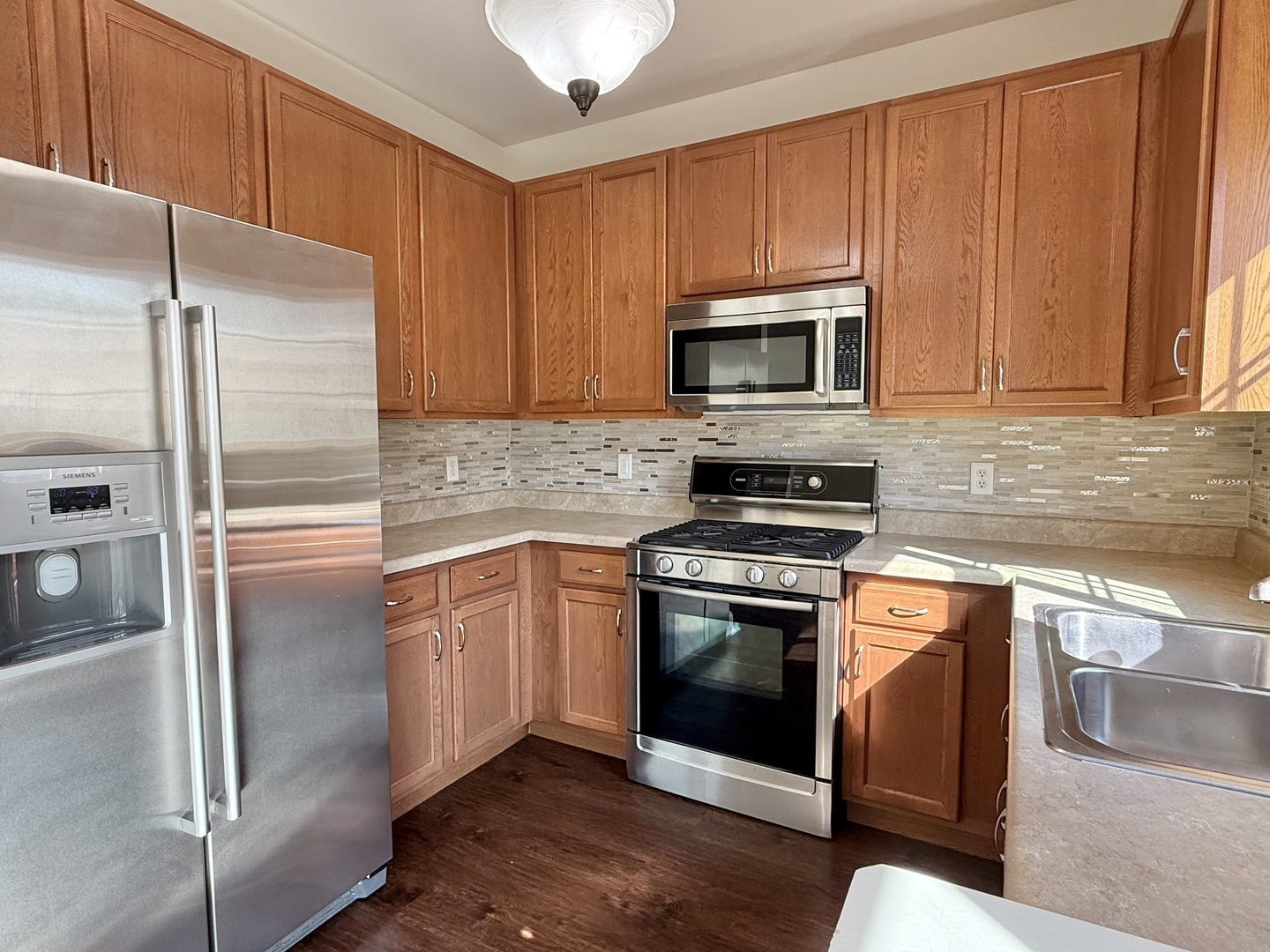 1392 Carolyn Court Yorkville, IL 60560 - Photo 5 of 23 a kitchen with granite countertop wooden cabinets stainless steel appliances and a counter space