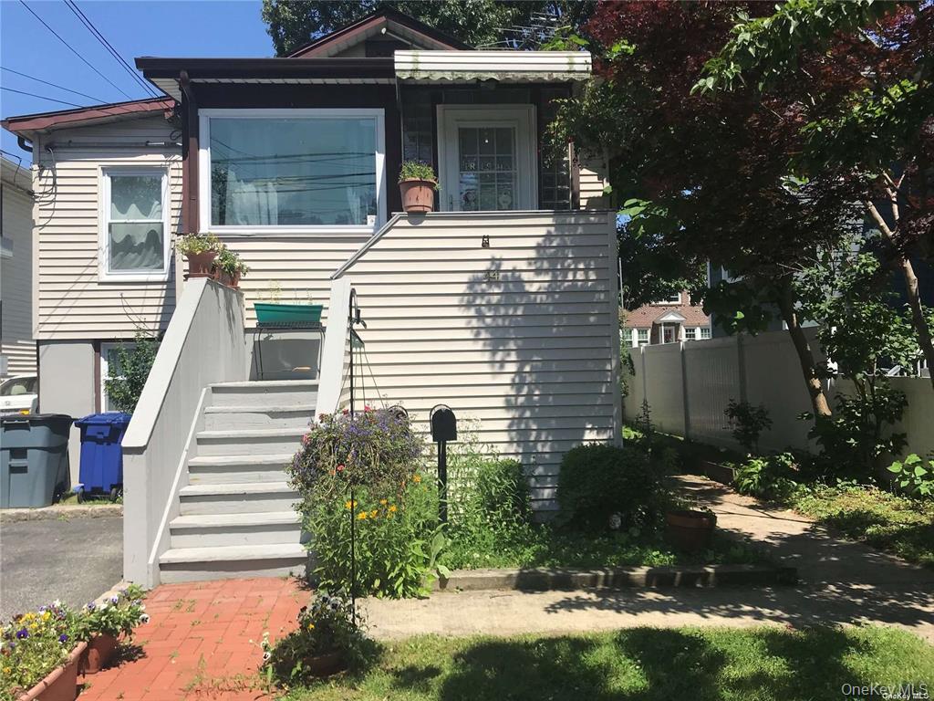 44 Graywood Road, Unit 2 Port Washington, NY 11050 - Photo 1 of 17 a view of a house with more windows and plants