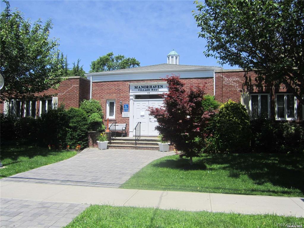 44 Graywood Road, Unit 2 Port Washington, NY 11050 - Photo 16 of 17 front view of house with a yard and potted plants