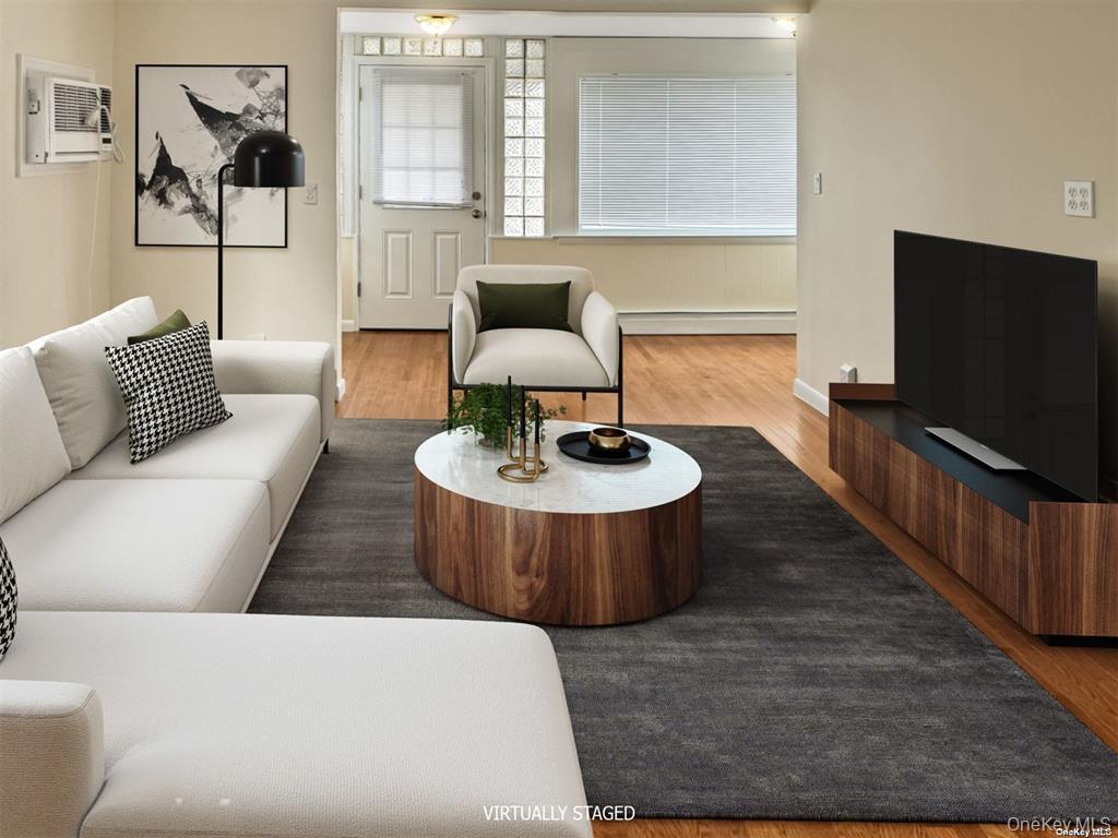 44 Graywood Road, Unit 2 Port Washington, NY 11050 - Photo 5 of 17 a living room with furniture and a flat screen tv