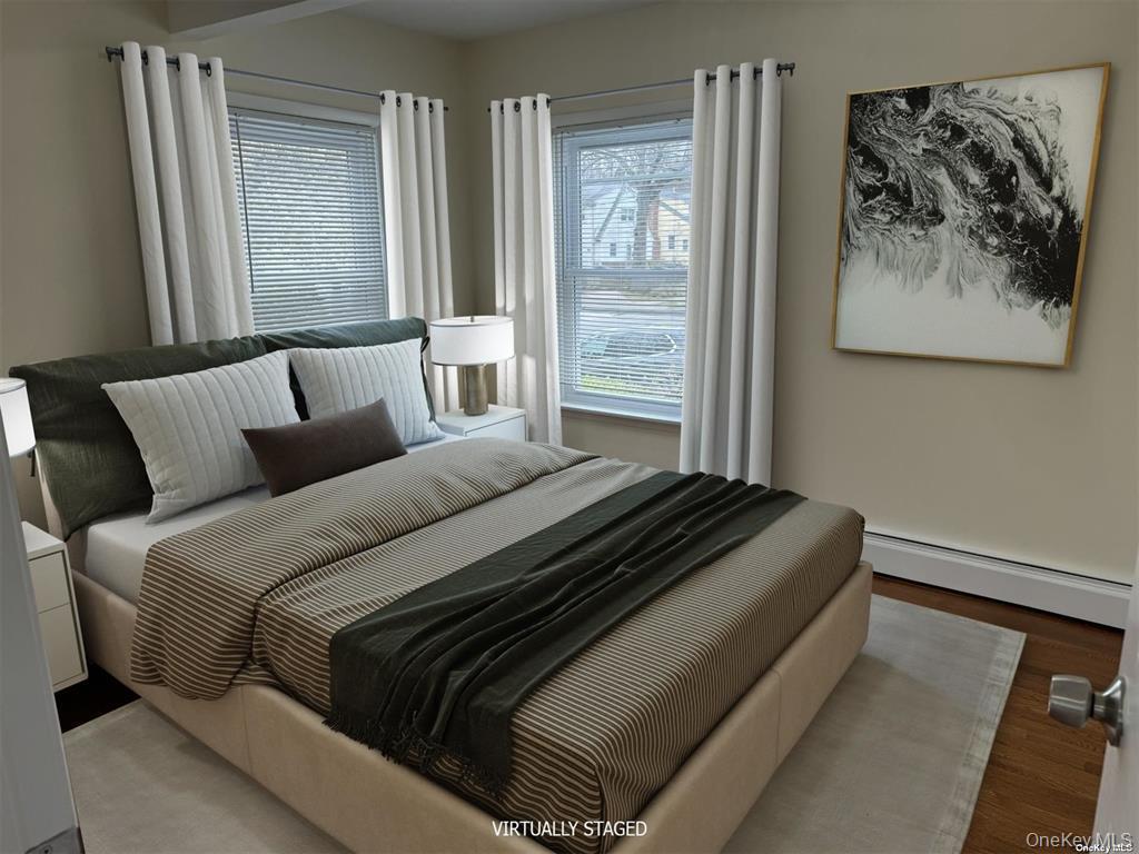 44 Graywood Road, Unit 2 Port Washington, NY 11050 - Photo 7 of 17 a bed sitting in a bedroom next to a window