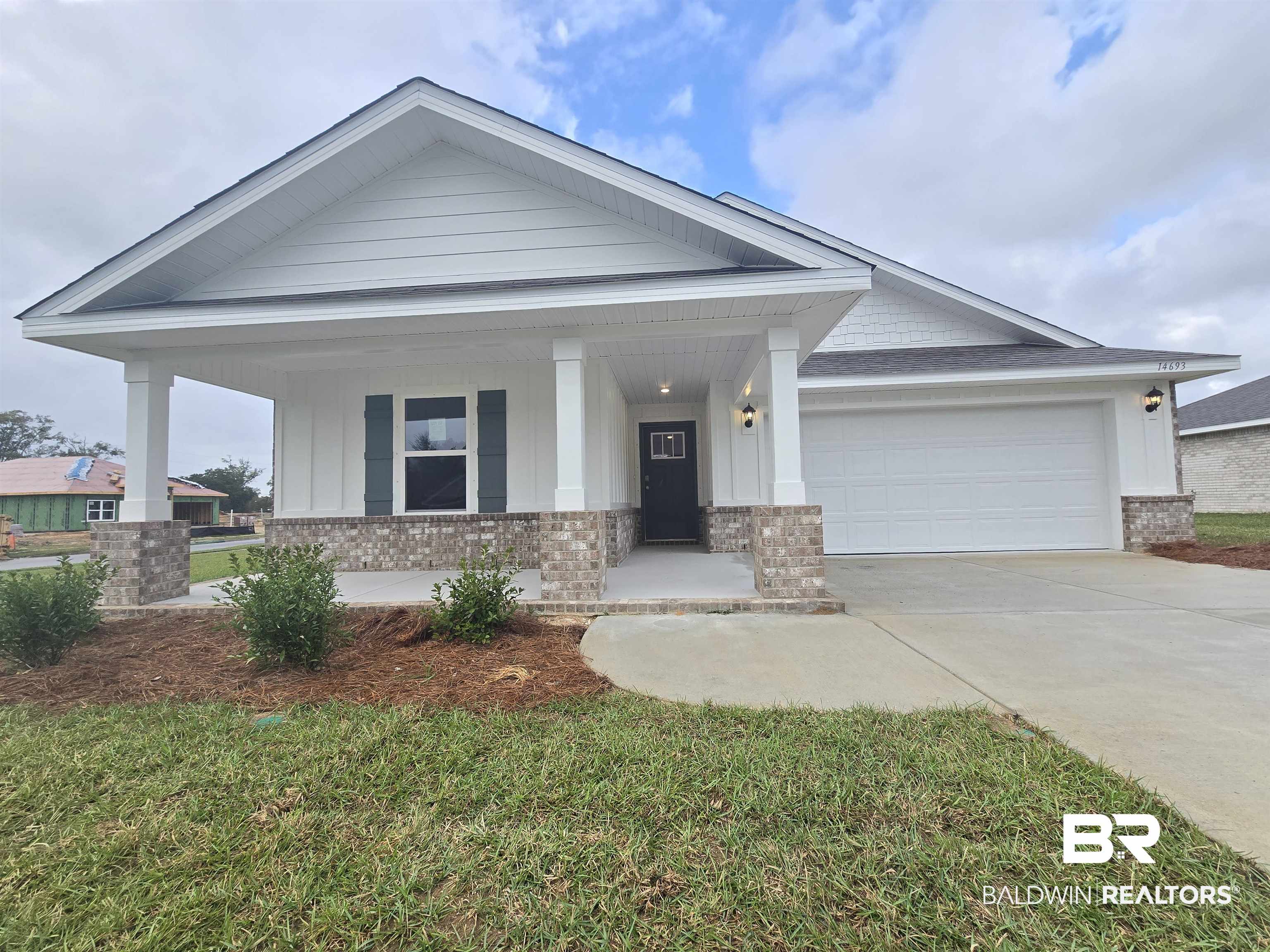14693 Dayton Circle Foley, AL 36535 - Photo 1 of 30 View of front of house featuring a front lawn, a garage, and a porch