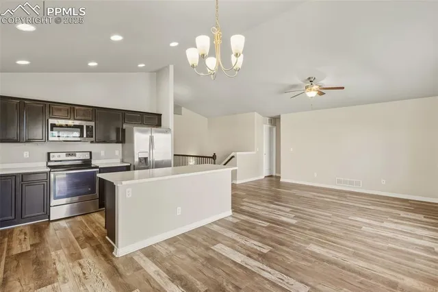 a view of kitchen with sink microwave and stove