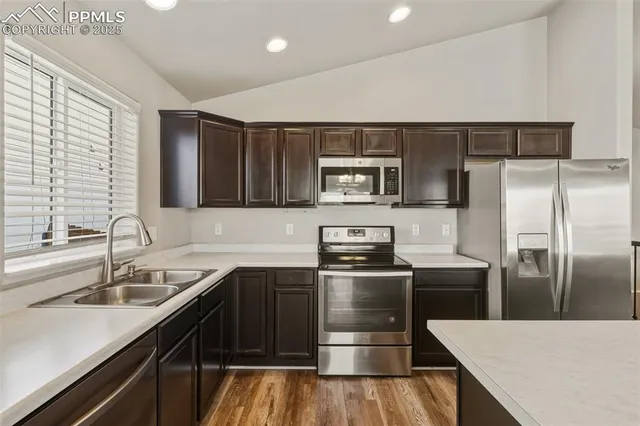 a kitchen with a sink appliances and cabinets