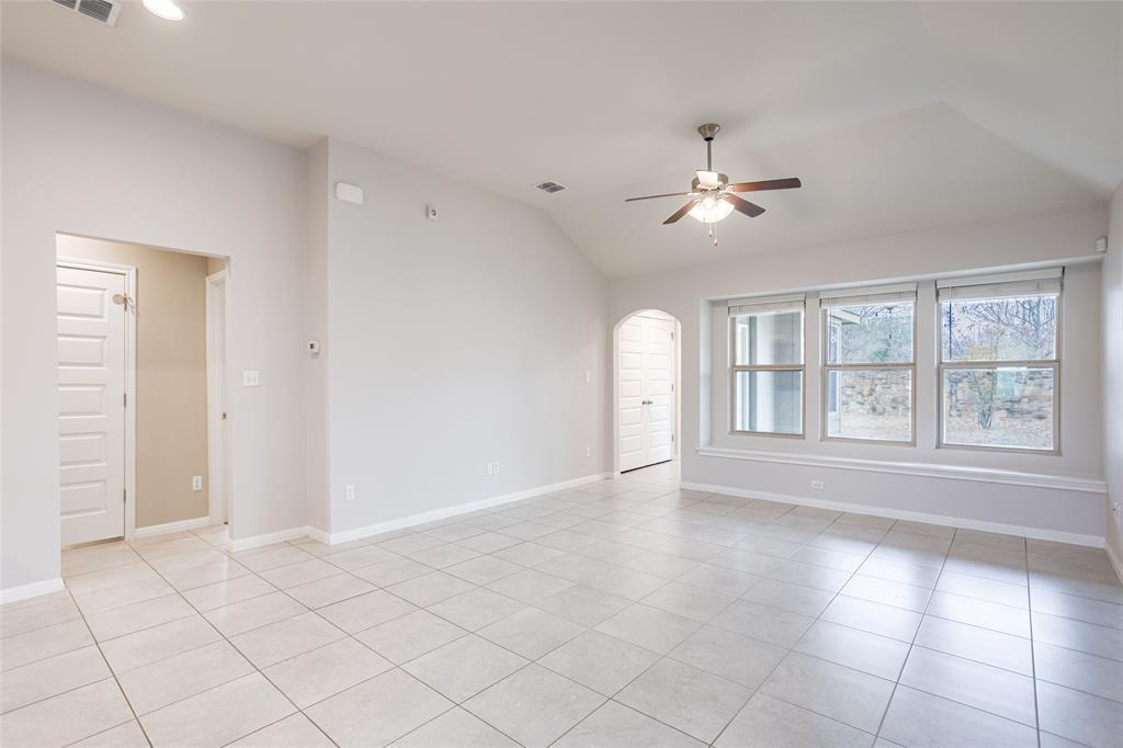 615 Stampede Road San Marcos, TX 78666 - Photo 16 of 26 Vast tile flooring leads to multiple windows, filling this spacious living area with natural light.