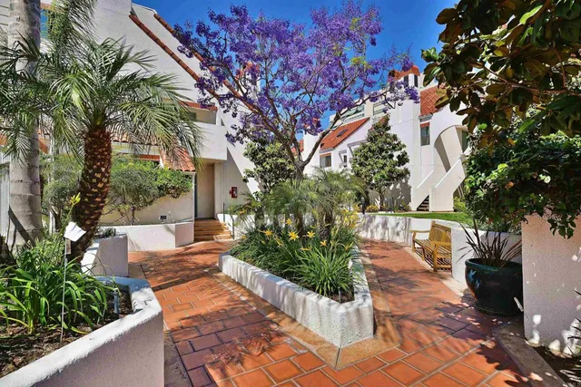 a view of a dinning table and chairs in patio of the house
