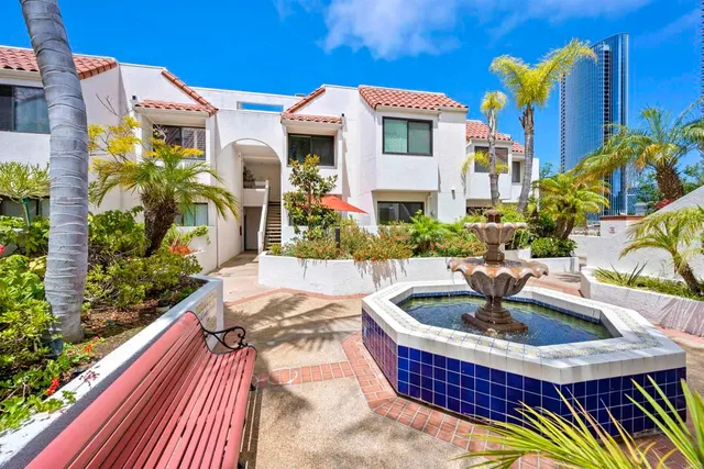 a view of a house with a yard and sitting area