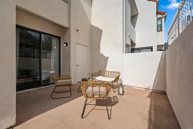 a view of a house with fountain and potted plants