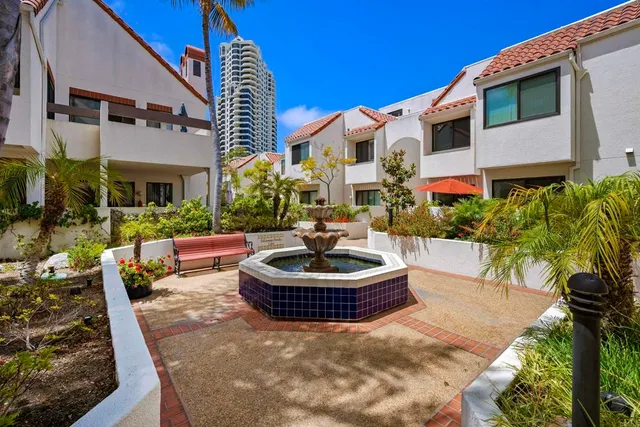 a view of a fountain in front of a house