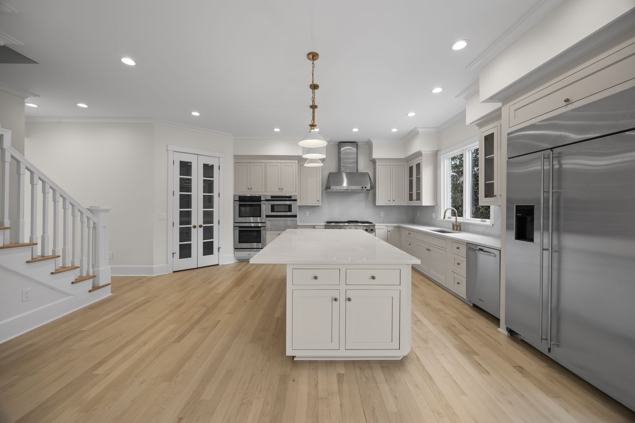 833 Highgrove Circle Franklin, TN 37069 - Photo 25 of 83 a large kitchen with stainless steel appliances kitchen island a large counter top and wooden floors