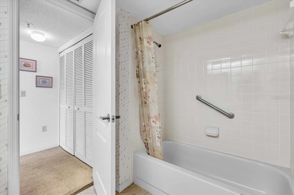 6501 Stone River Road, Unit 209 Bradenton, FL 34203 - Photo 11 of 45 a bathroom with a bathtub and a shower