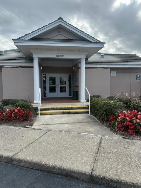 6501 Stone River Road, Unit 209 Bradenton, FL 34203 - Photo 27 of 45 a view of a house with potted plants and more windows