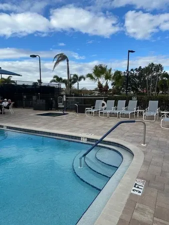 a view of a swimming pool with outdoor seating