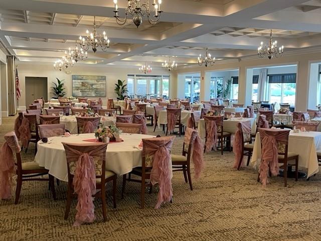 6501 Stone River Road, Unit 209 Bradenton, FL 34203 - Photo 38 of 45 a large dining space with lots of furniture and chandelier