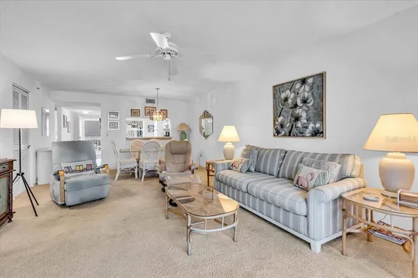 a living room with furniture a table and a lamp