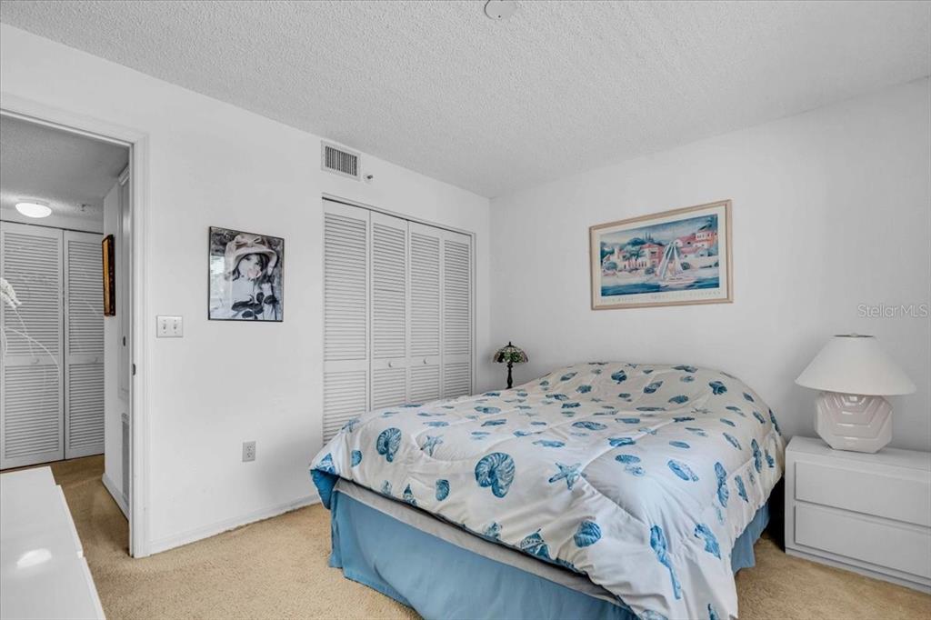 6501 Stone River Road, Unit 209 Bradenton, FL 34203 - Photo 9 of 45 a bedroom with a bed and wall painting