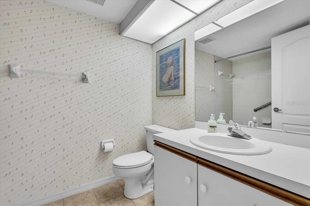 6501 Stone River Road, Unit 209 Bradenton, FL 34203 - Photo 10 of 45 a bathroom with a sink a toilet and mirror