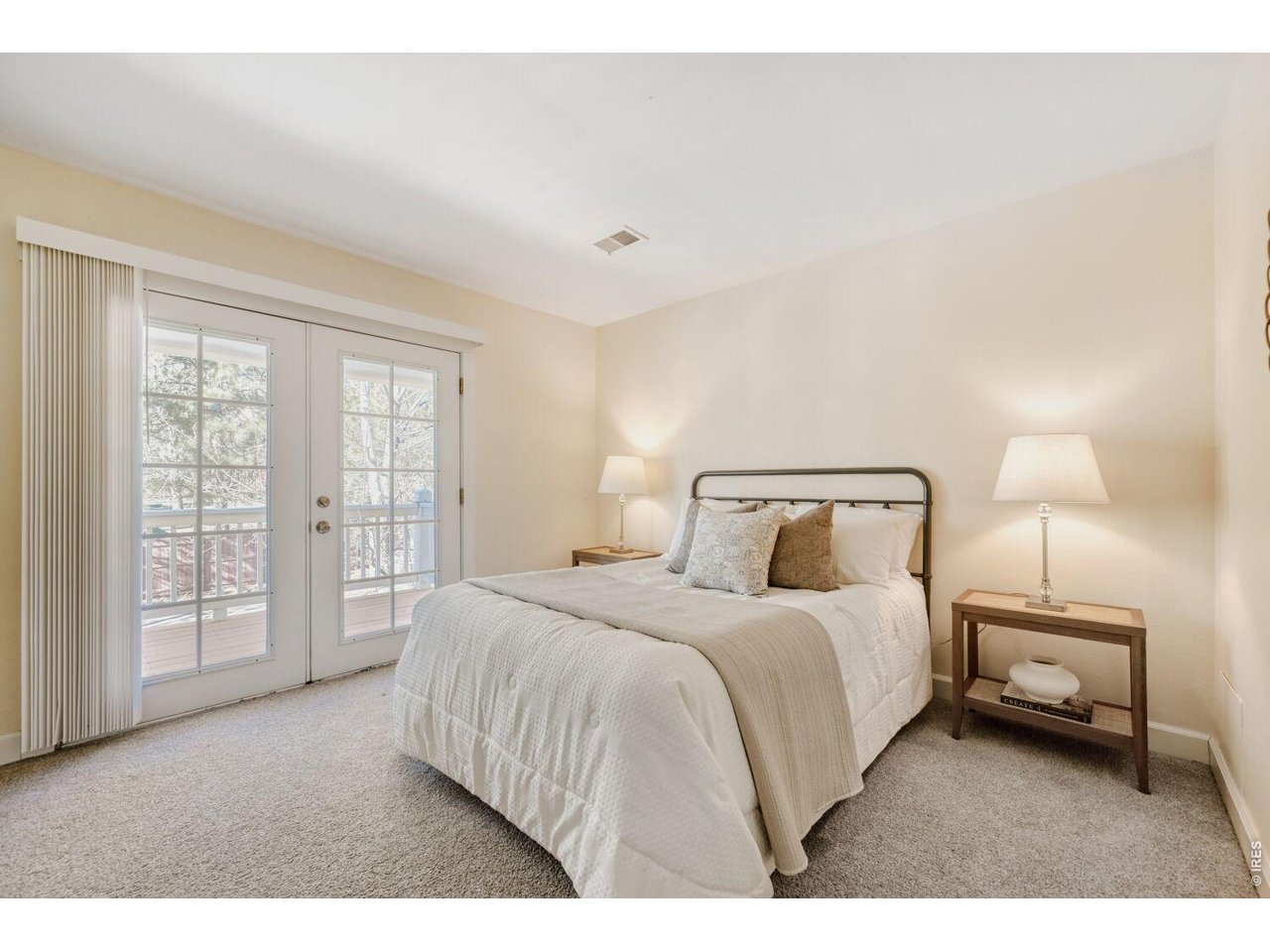 3515 Broadway, Unit B Boulder, CO 80304 - Photo 11 of 37 a bedroom with a bed a lamp and a large window