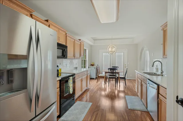 a view of a kitchen with dining room and wooden floor