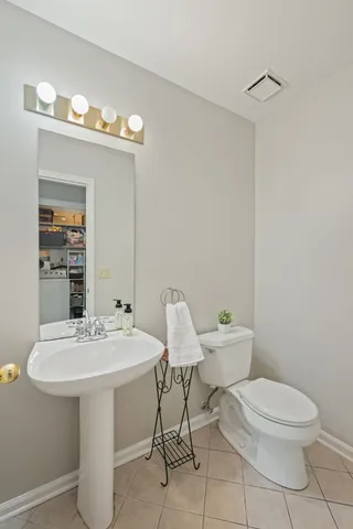 a bathroom with a toilet a sink and a mirror