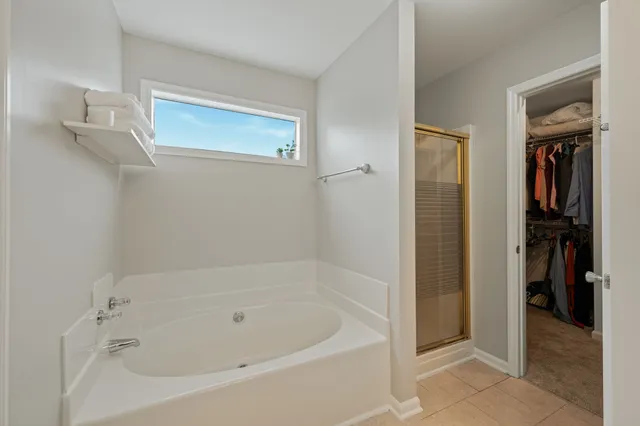 a white bath tub sitting next to a bathroom