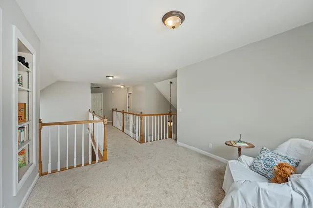 a view of a livingroom with furniture and staircase