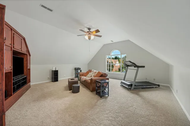 a living room with furniture gym equipment and a fireplace
