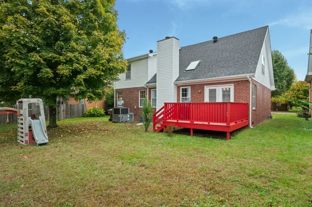 a view of a house with a backyard and a patio