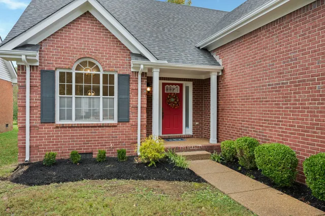 a front view of a house with garden