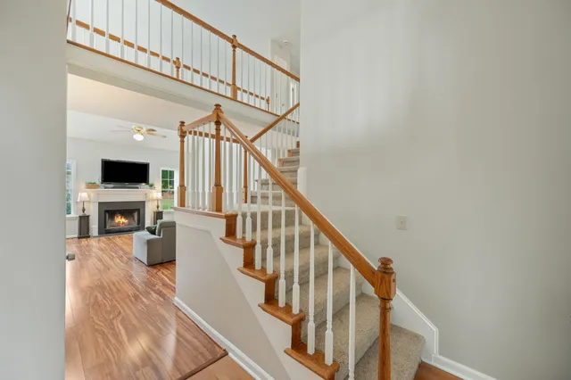 a view of entryway and hall with wooden floor