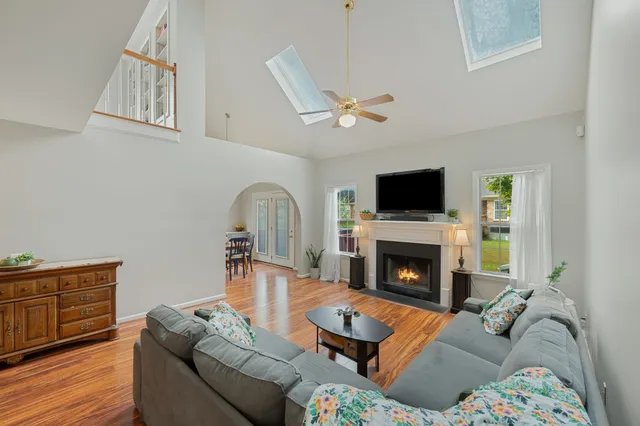 a living room with furniture fireplace and flat screen tv