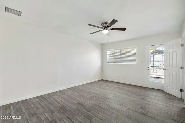 a view of kitchen with refrigerator and wooden floor