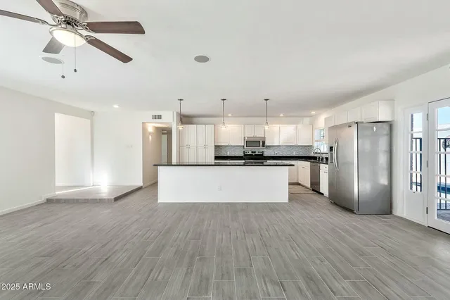 a view of a kitchen with a sink and a refrigerator