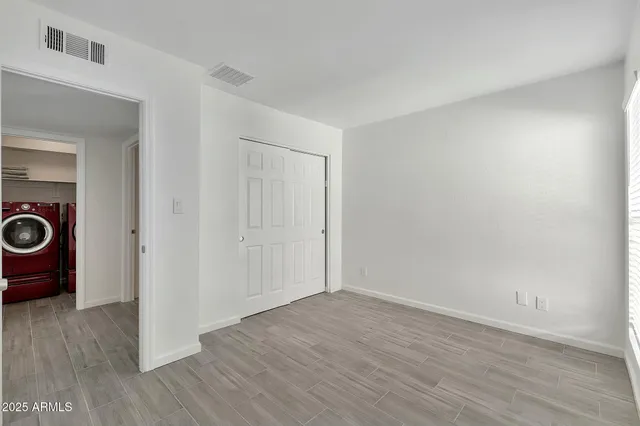 a view of an empty room and wooden floor
