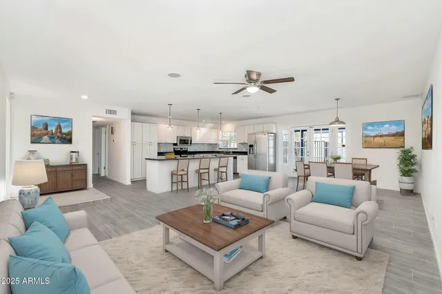 a living room with furniture and kitchen view
