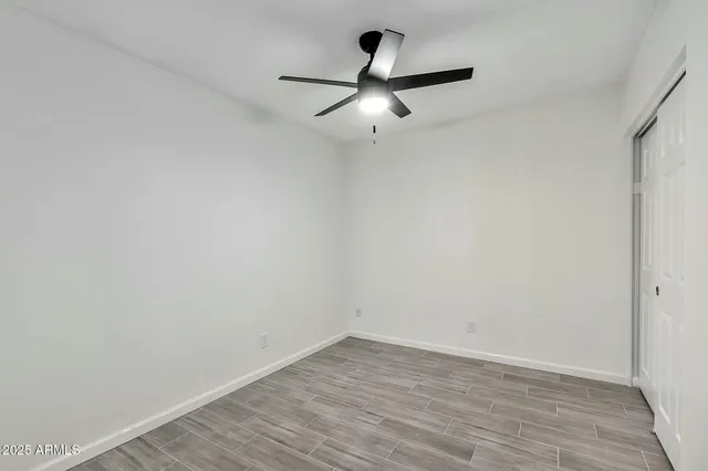 a view of a big room with wooden floor and mirror