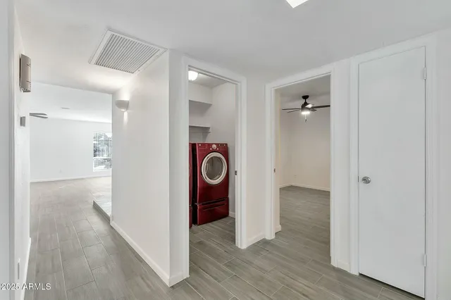 a bathroom with a granite countertop toilet a sink and a mirror