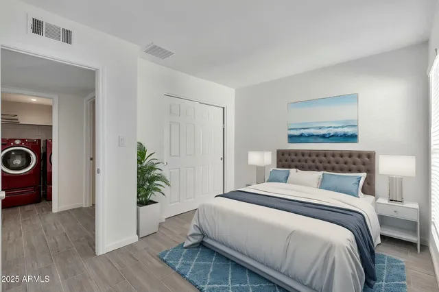 a bedroom with a bed and a potted plant