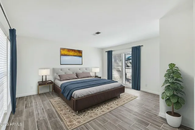 a spacious bedroom with a bed and a window