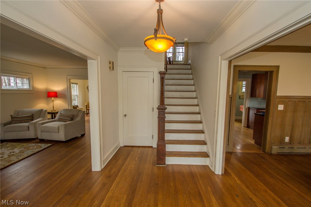 Front entry, staircase leads to office off landing and pocket door opens to second floor.