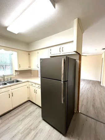 a kitchen with stainless steel appliances a refrigerator and a sink