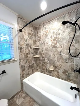 a bathroom with a bathtub and a shower