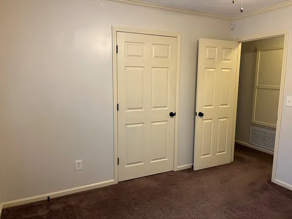an empty room with closet area