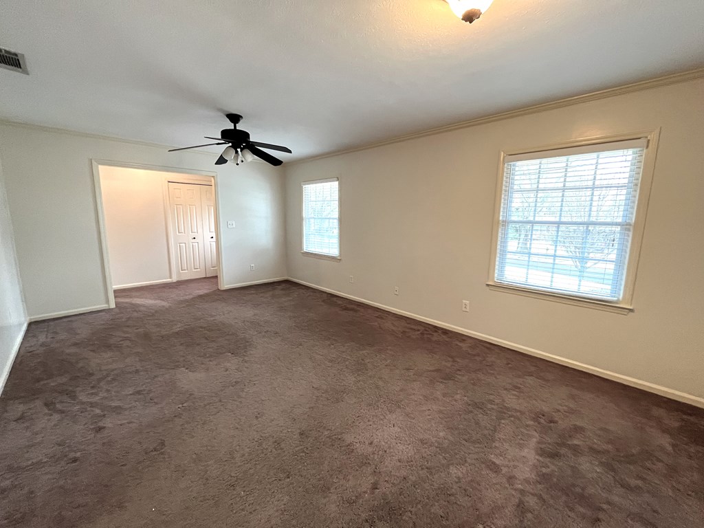 2113 Leeds Drive Columbus, GA 31904 - Photo 8 of 28 an empty room with windows and ceiling fan