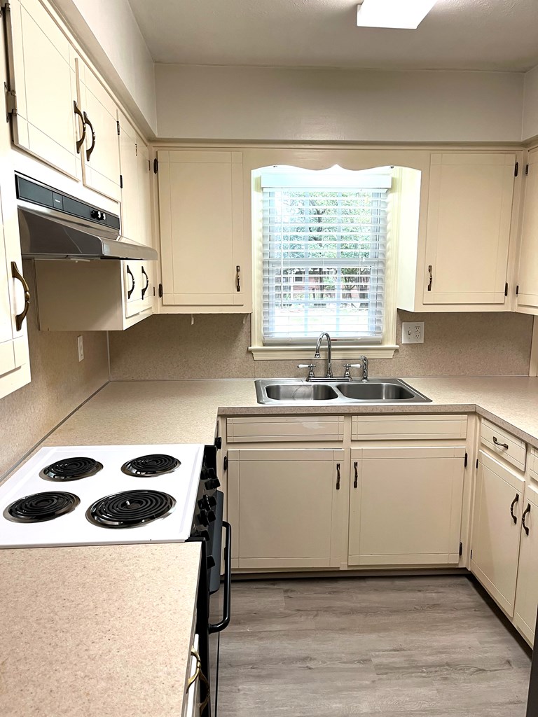 2113 Leeds Drive Columbus, GA 31904 - Photo 9 of 28 a kitchen with a white cabinets and wooden floor