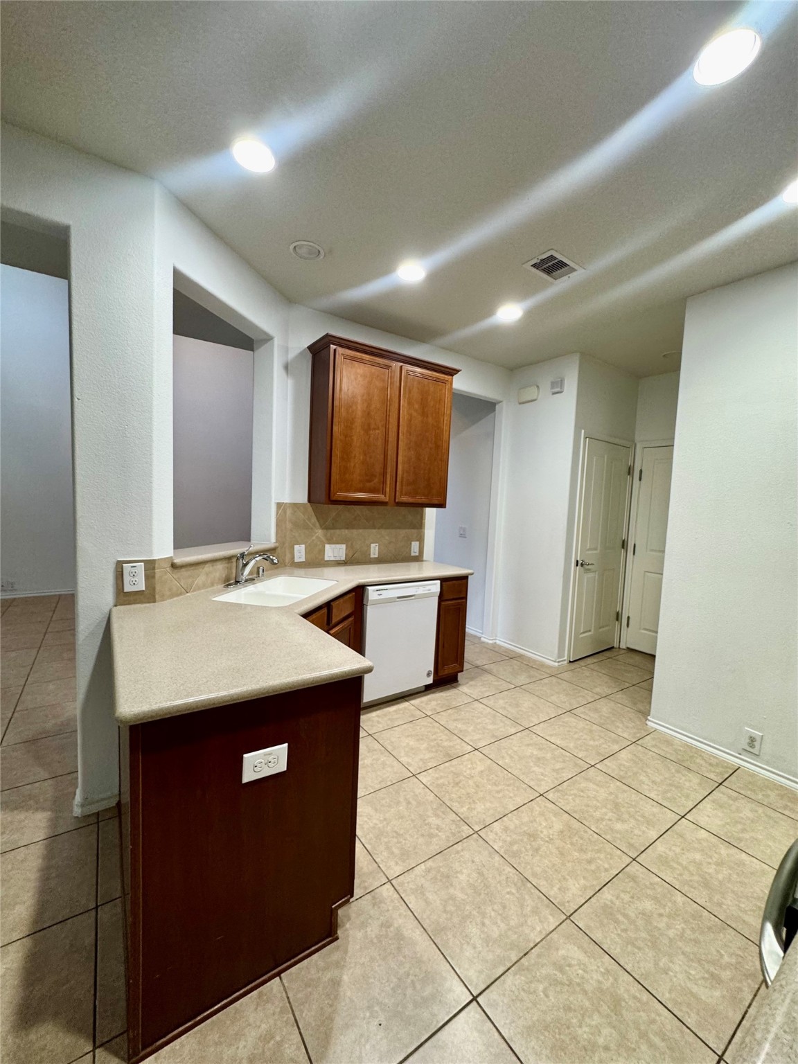 13600 Breton Ridge Street, Unit 36C Houston, TX 77070 - Photo 30 of 40 a kitchen with stainless steel appliances granite countertop a sink and a refrigerator